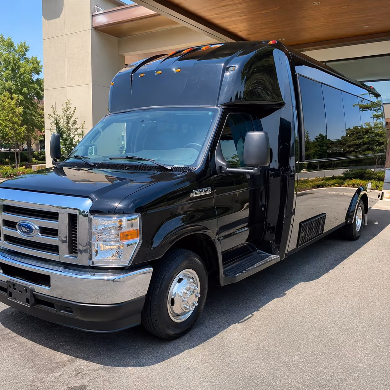 Group beside a Mercedes Sprinter limo in Austin